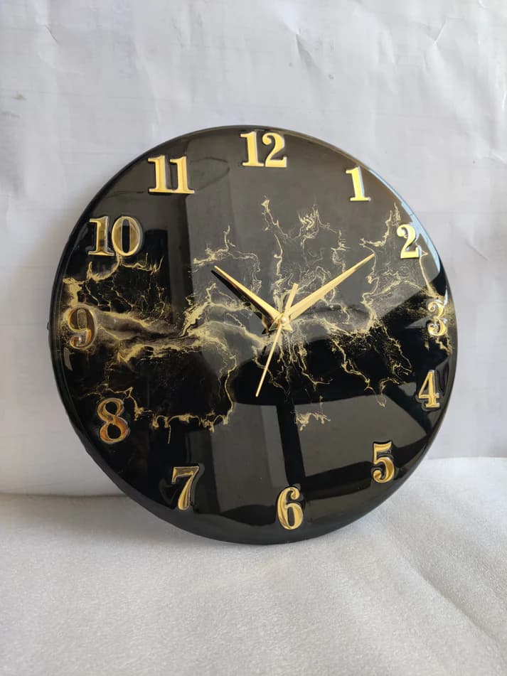Black resin wall clock with golden blast for vastu