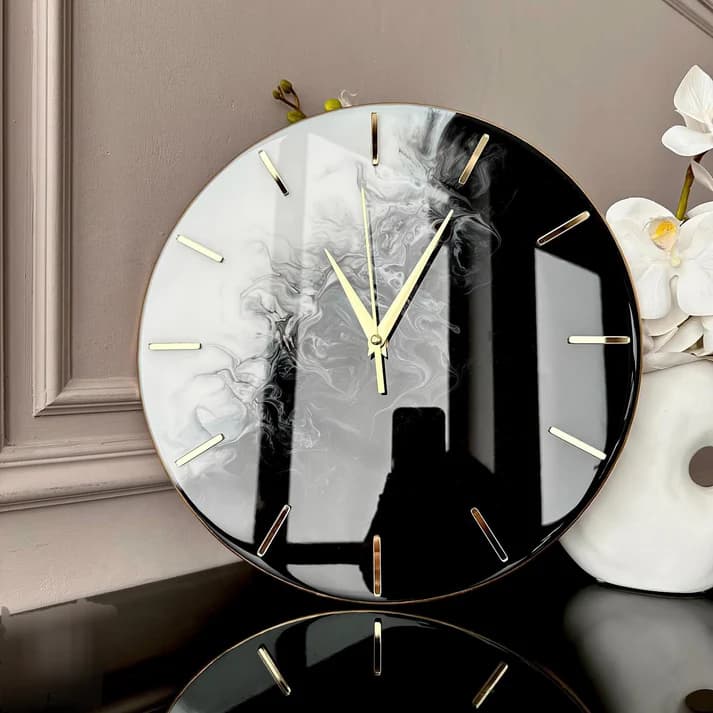 Black and white resin wall clock with gold bezel craftsmanship